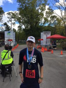 I smile and pose for a picture after completing my half marathon goal.